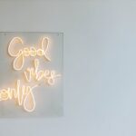 White Led Light Sign on Glass Hanging on Gray Wall